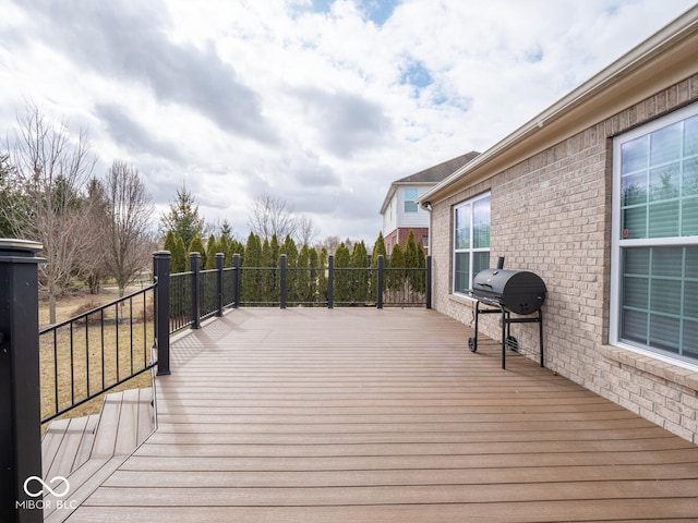 wooden deck with a grill