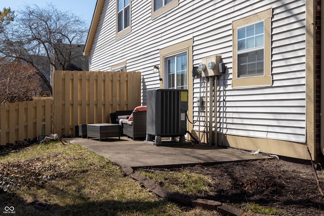 exterior space featuring central AC unit and fence