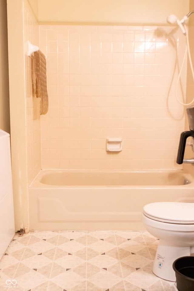 bathroom with tile patterned floors, tub / shower combination, and toilet