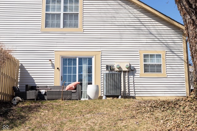 rear view of property with a lawn and an outdoor hangout area