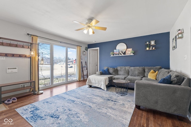 living room with ceiling fan and dark wood-style flooring