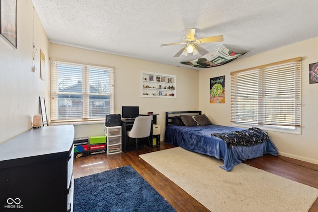 bedroom featuring multiple windows and wood finished floors