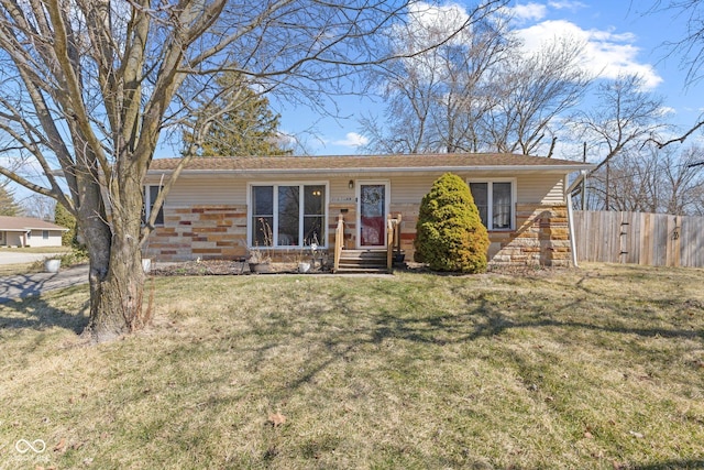 single story home featuring a front yard and fence