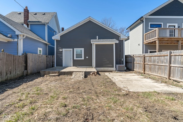 569 N Tacoma Ave, Indianapolis, IN 46201 - rear view of house with a patio and a fenced backyard