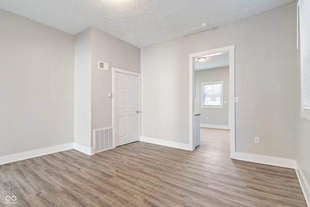569 N Tacoma Ave, Indianapolis, IN 46201 - unfurnished room with visible vents, baseboards, and wood finished floors