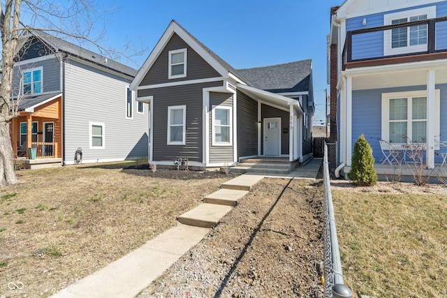 view of front of house with a porch and a shingled roof