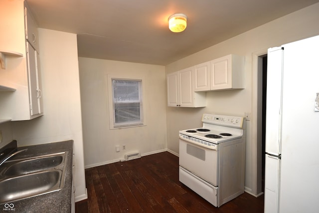 kitchen with dark wood-type flooring, white cabinetry, a sink, white appliances, and baseboards