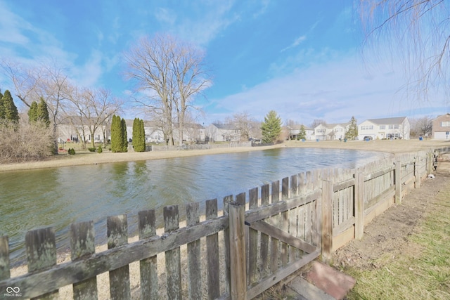 water view featuring a residential view and fence