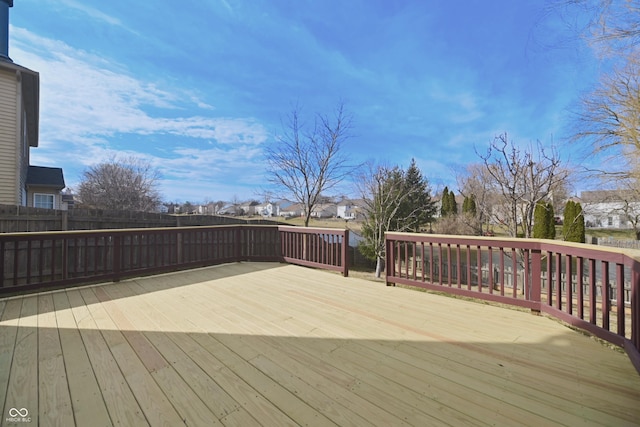 wooden terrace with fence and a residential view