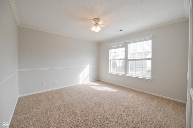 carpeted empty room featuring a textured ceiling, visible vents, and crown molding