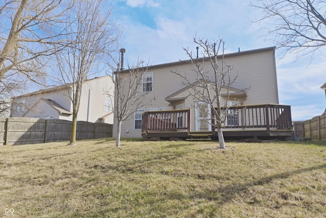 back of house featuring a yard, a fenced backyard, and a wooden deck