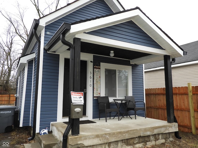 exterior space with covered porch and fence