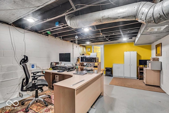 office featuring concrete block wall and concrete flooring