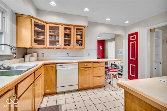 kitchen with light countertops, light tile patterned floors, recessed lighting, white dishwasher, and a sink