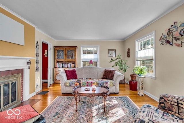 living area with a healthy amount of sunlight, light wood-style flooring, and a fireplace