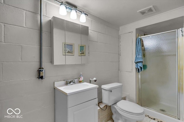 bathroom featuring visible vents, a stall shower, toilet, and vanity