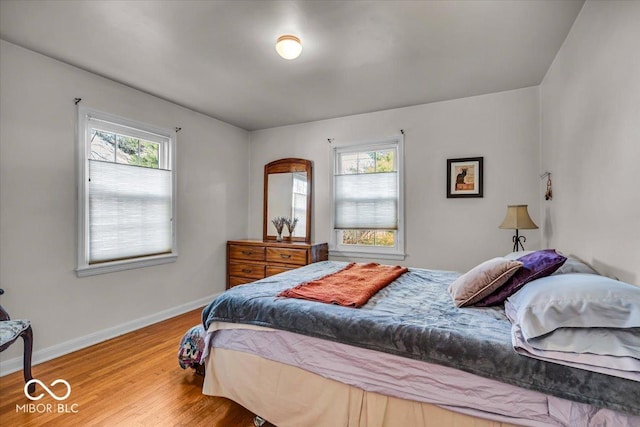 bedroom with baseboards and wood finished floors