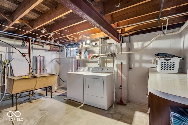 washroom with washer and dryer, laundry area, and a sink