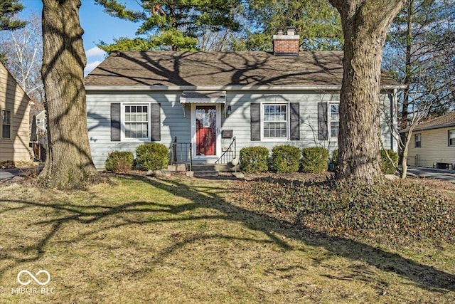 view of front of house with a chimney and a front yard