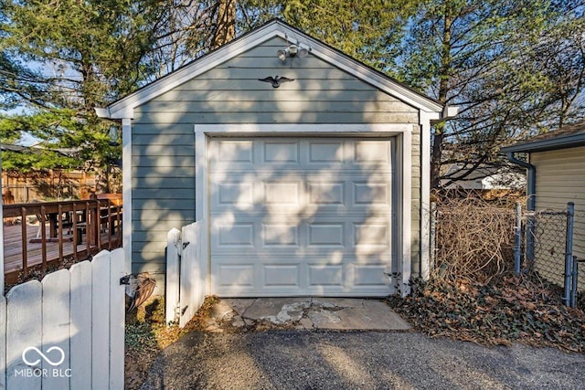 detached garage featuring fence