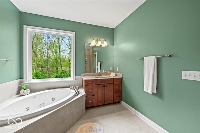 681 Greenford Trl N, Carmel, IN 46032 - bathroom with vanity, a jetted tub, plenty of natural light, and tile patterned floors