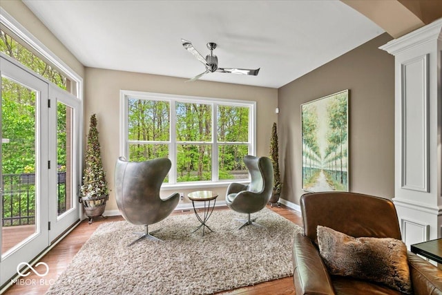681 Greenford Trl N, Carmel, IN 46032 - sitting room with healthy amount of natural light, ornate columns, and wood finished floors