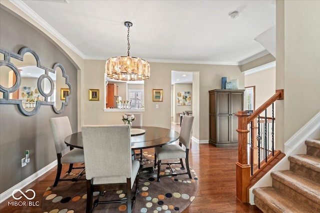 681 Greenford Trl N, Carmel, IN 46032 - dining room with stairway, wood finished floors, a chandelier, ornamental molding, and plenty of natural light