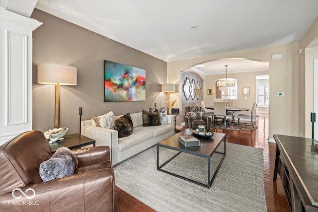681 Greenford Trl N, Carmel, IN 46032 - living room featuring arched walkways, wood finished floors, and a chandelier