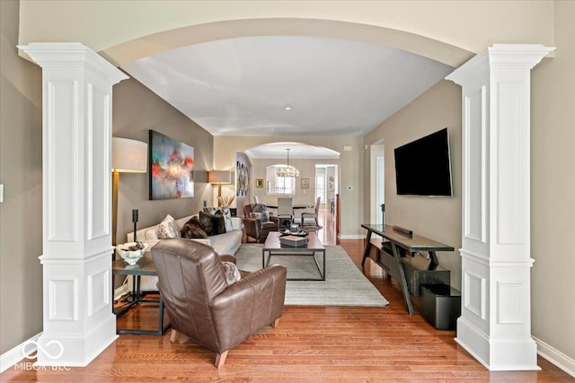 681 Greenford Trl N, Carmel, IN 46032 - living room with arched walkways, light wood-type flooring, and ornate columns