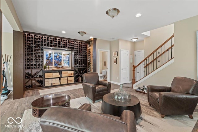681 Greenford Trl N, Carmel, IN 46032 - living area featuring wood finished floors, stairway, and recessed lighting