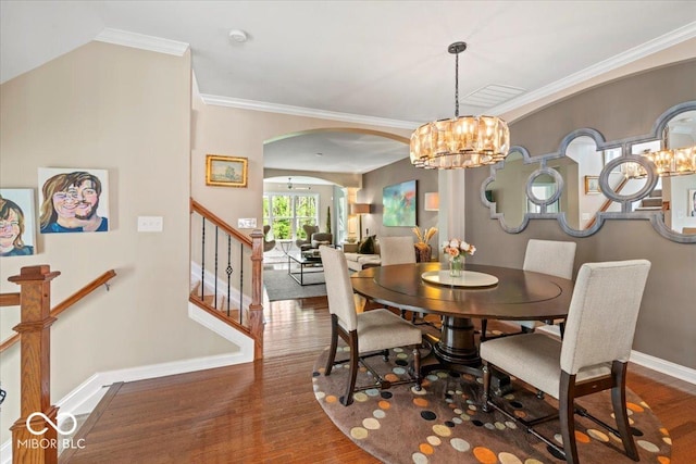 681 Greenford Trl N, Carmel, IN 46032 - dining space with arched walkways, wood finished floors, a chandelier, and ornamental molding