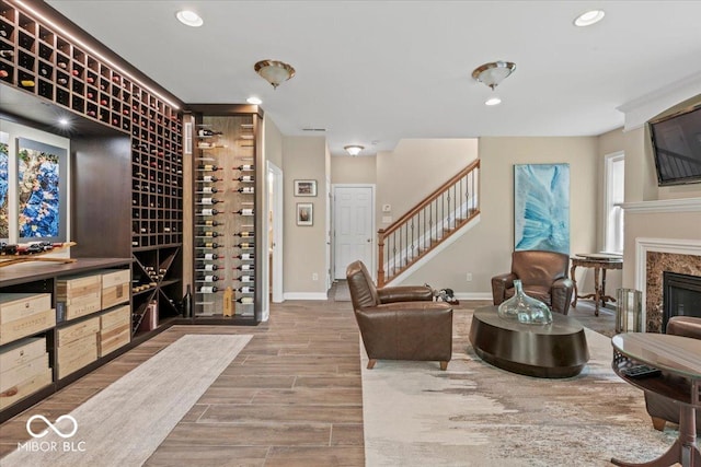 681 Greenford Trl N, Carmel, IN 46032 - wine cellar featuring recessed lighting, wood finished floors, and a fireplace
