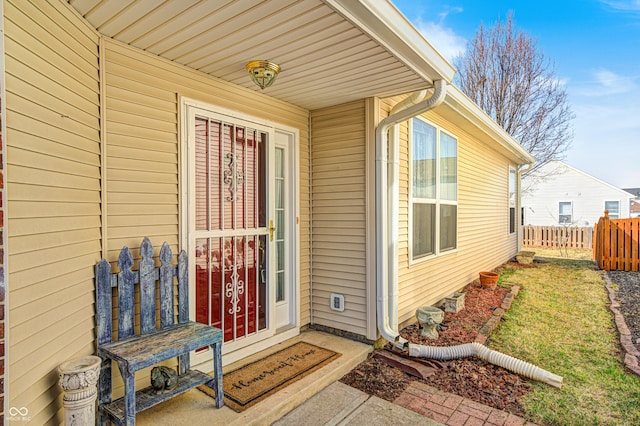 entrance to property featuring fence