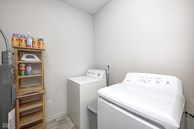 laundry room with baseboards, separate washer and dryer, laundry area, and water heater