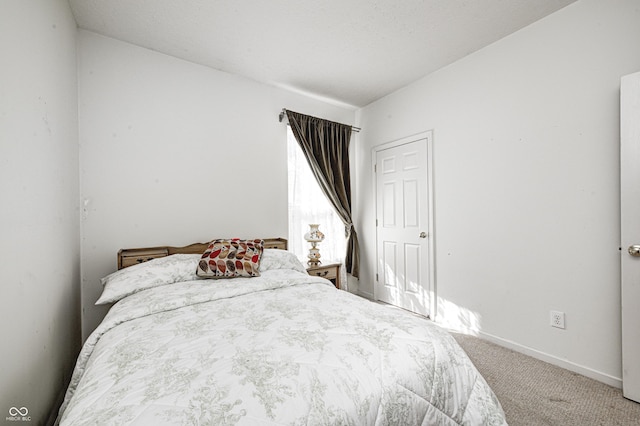 bedroom with baseboards and carpet floors