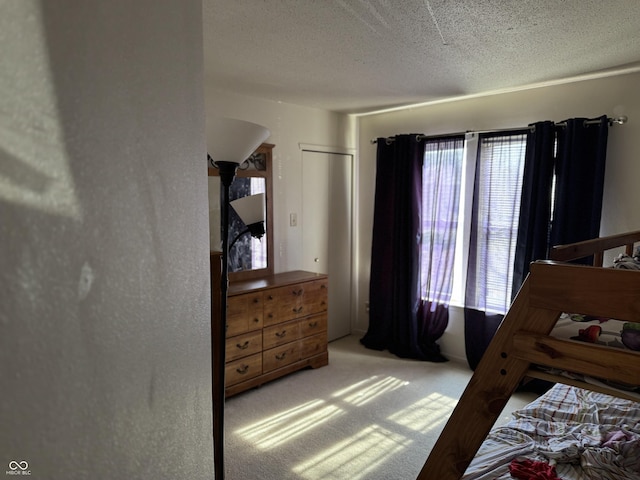 bedroom featuring arched walkways, carpet floors, and a textured ceiling