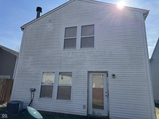 back of house with central air condition unit and fence