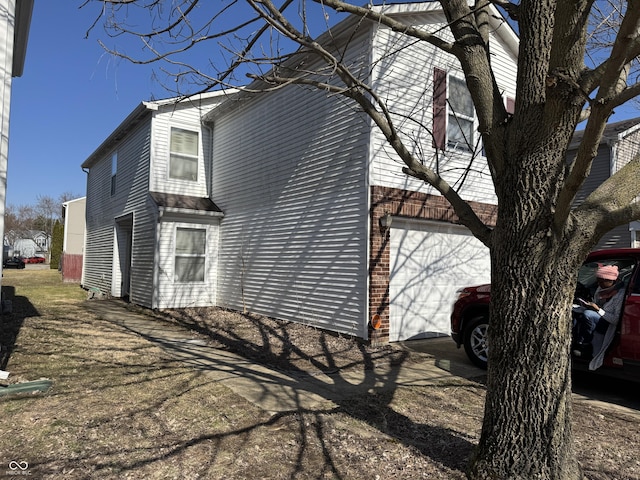 view of side of property featuring an attached garage