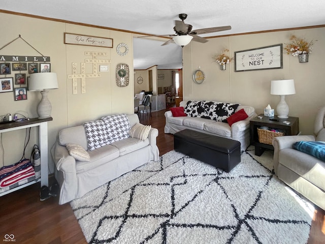 living area with ceiling fan, wood finished floors, and ornamental molding