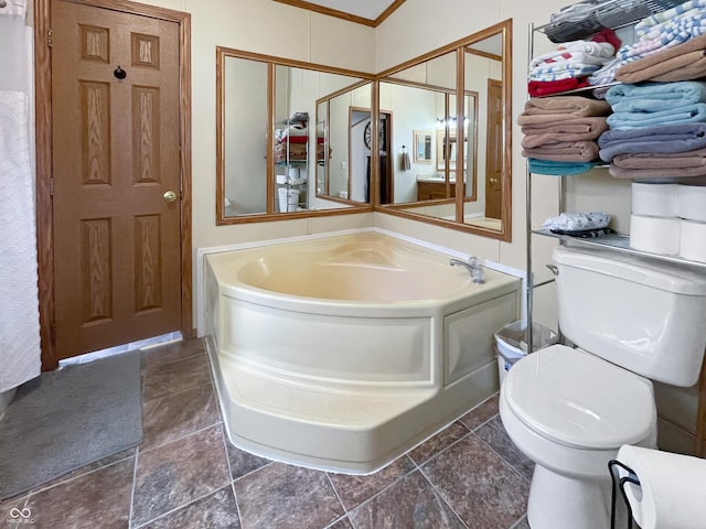 full bath featuring a garden tub and toilet