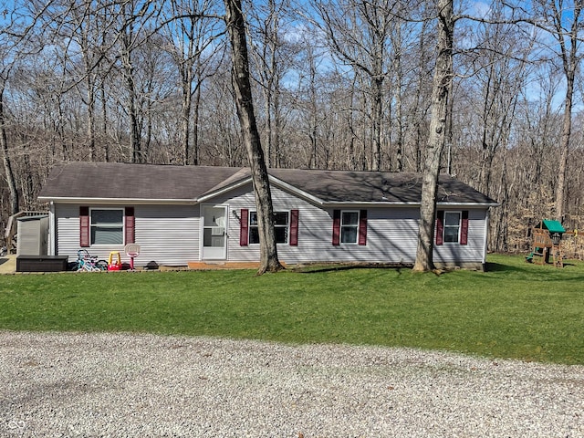 single story home with a front yard and a playground