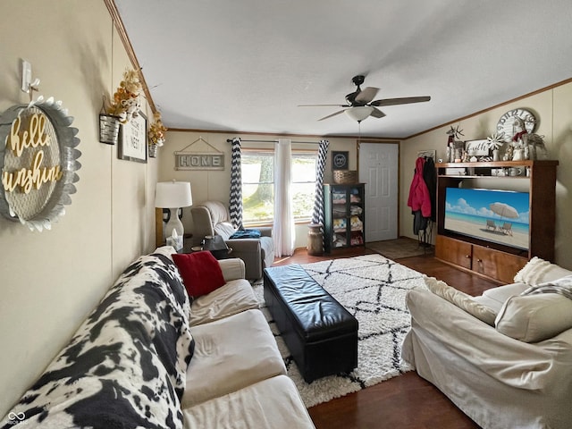 living room with crown molding, a ceiling fan, and wood finished floors