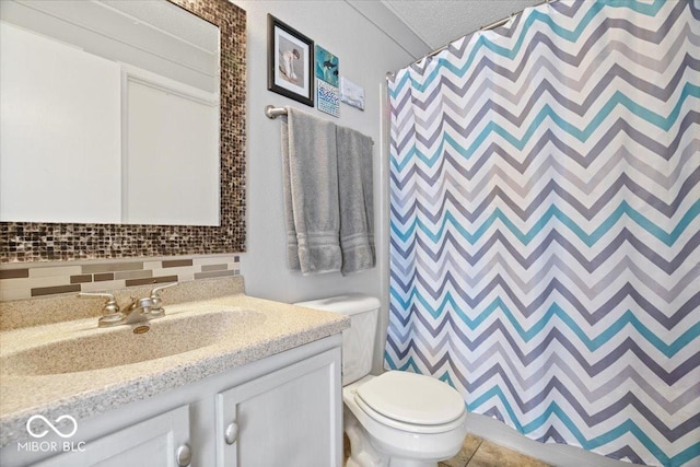 bathroom with tile patterned flooring, backsplash, curtained shower, toilet, and vanity