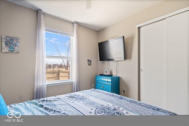 bedroom with a closet and a textured ceiling