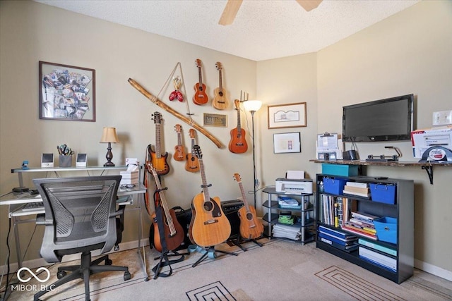 carpeted office featuring a textured ceiling and ceiling fan