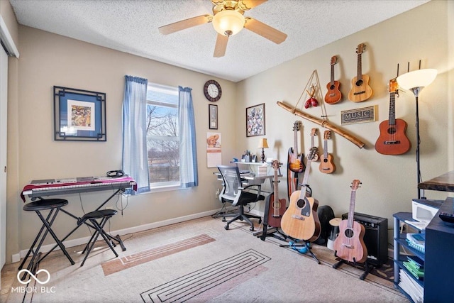 carpeted office with baseboards, a textured ceiling, and ceiling fan