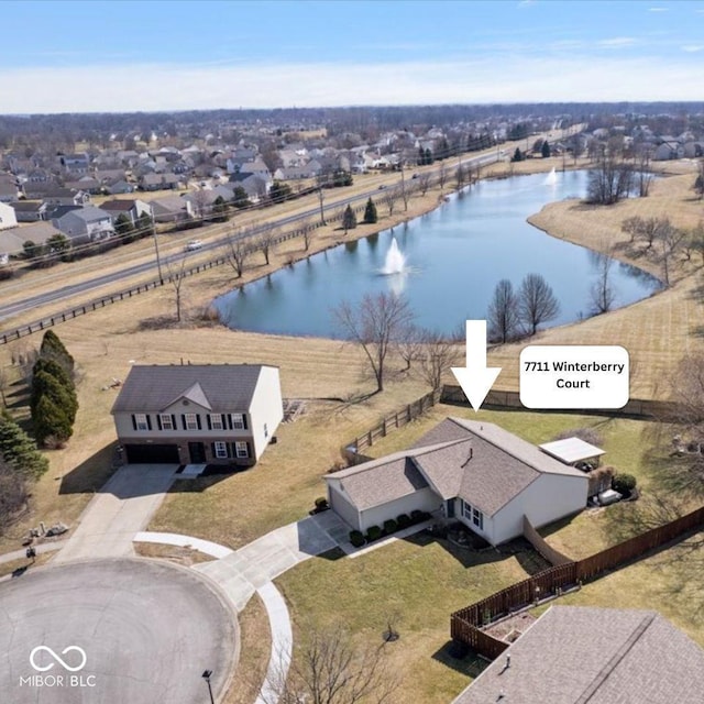 birds eye view of property featuring a residential view and a water view