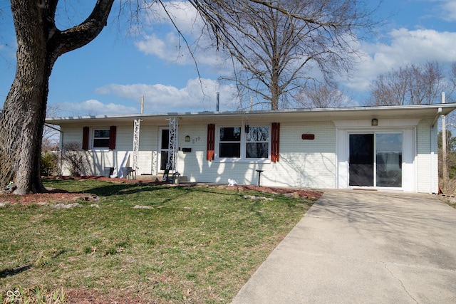 ranch-style home featuring brick siding, covered porch, and a front yard