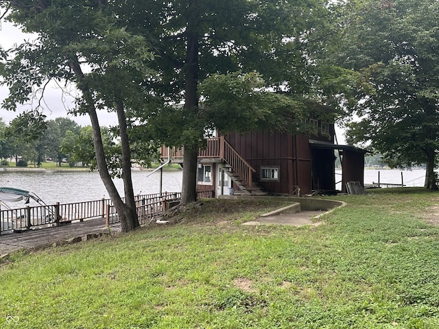 view of yard featuring a water view and stairway