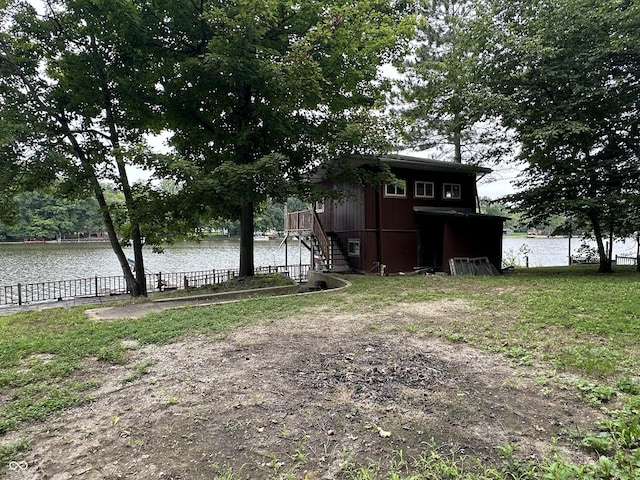 view of yard featuring a water view and stairway